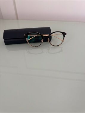 Warby Parker Round Black and Gold Eyeglasses with tortoise trim